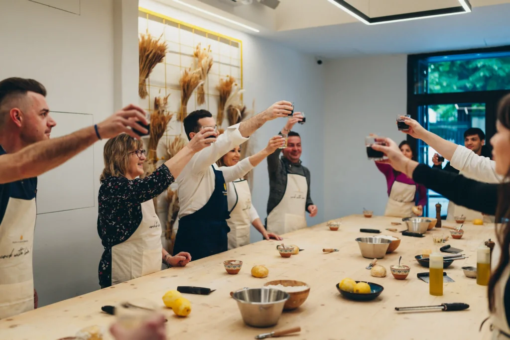 people doing cheers in a cooking class
