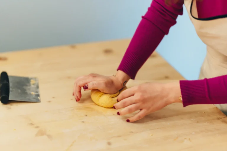 person kneading the dough