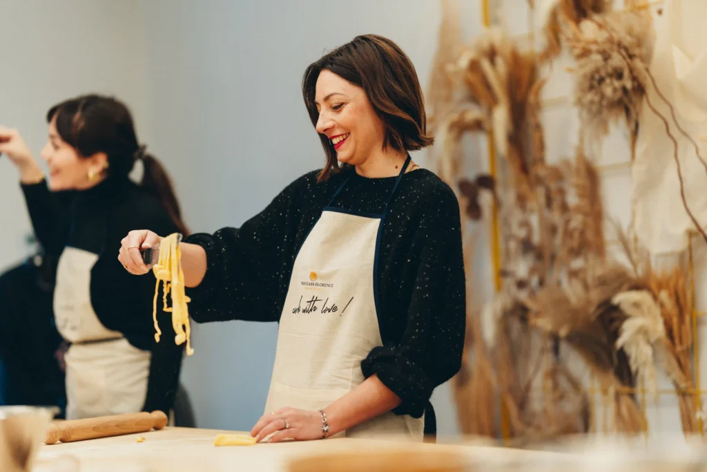person with pasta in a cooking class