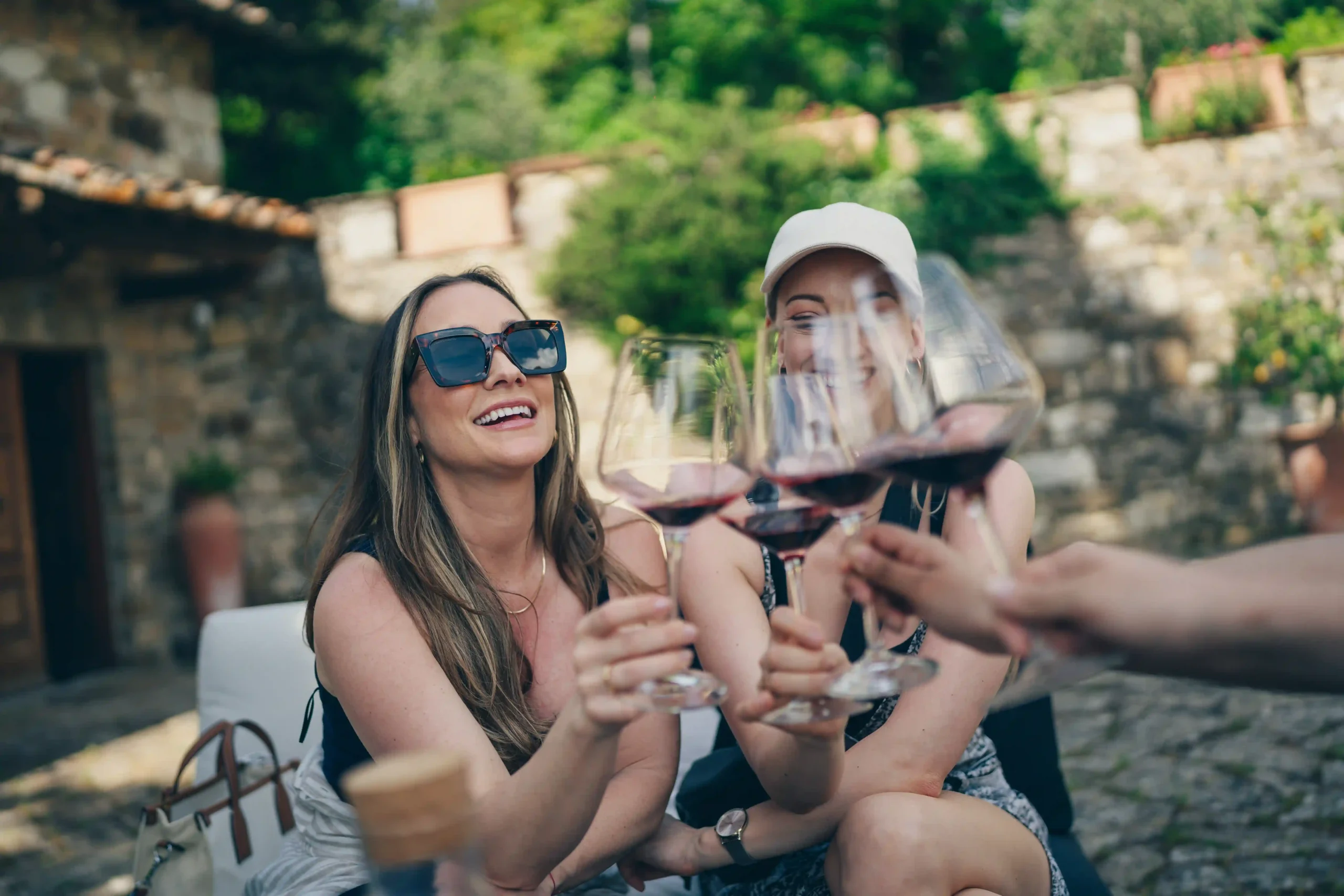 people doing cheers with glasses of wine