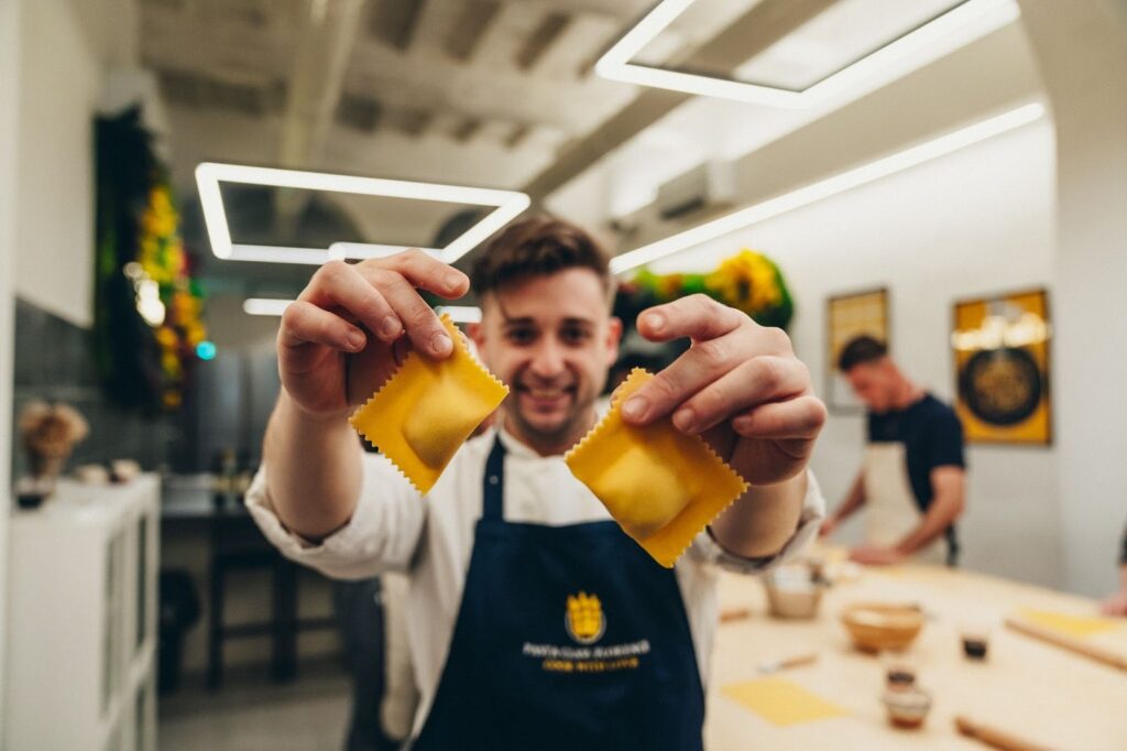 chef with two ravioli fresh pasta
