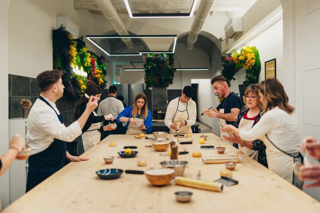 pasta cooking class in florence in a room full of people