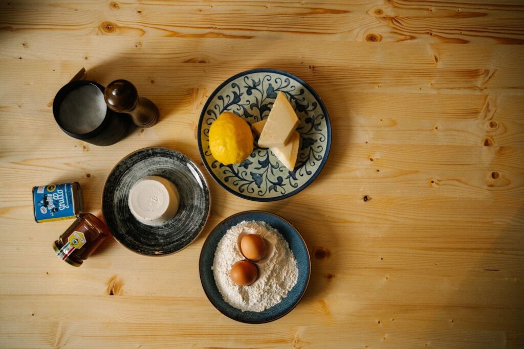 table with ricotta, lemon, parmigiano, eggs and other ingredients
