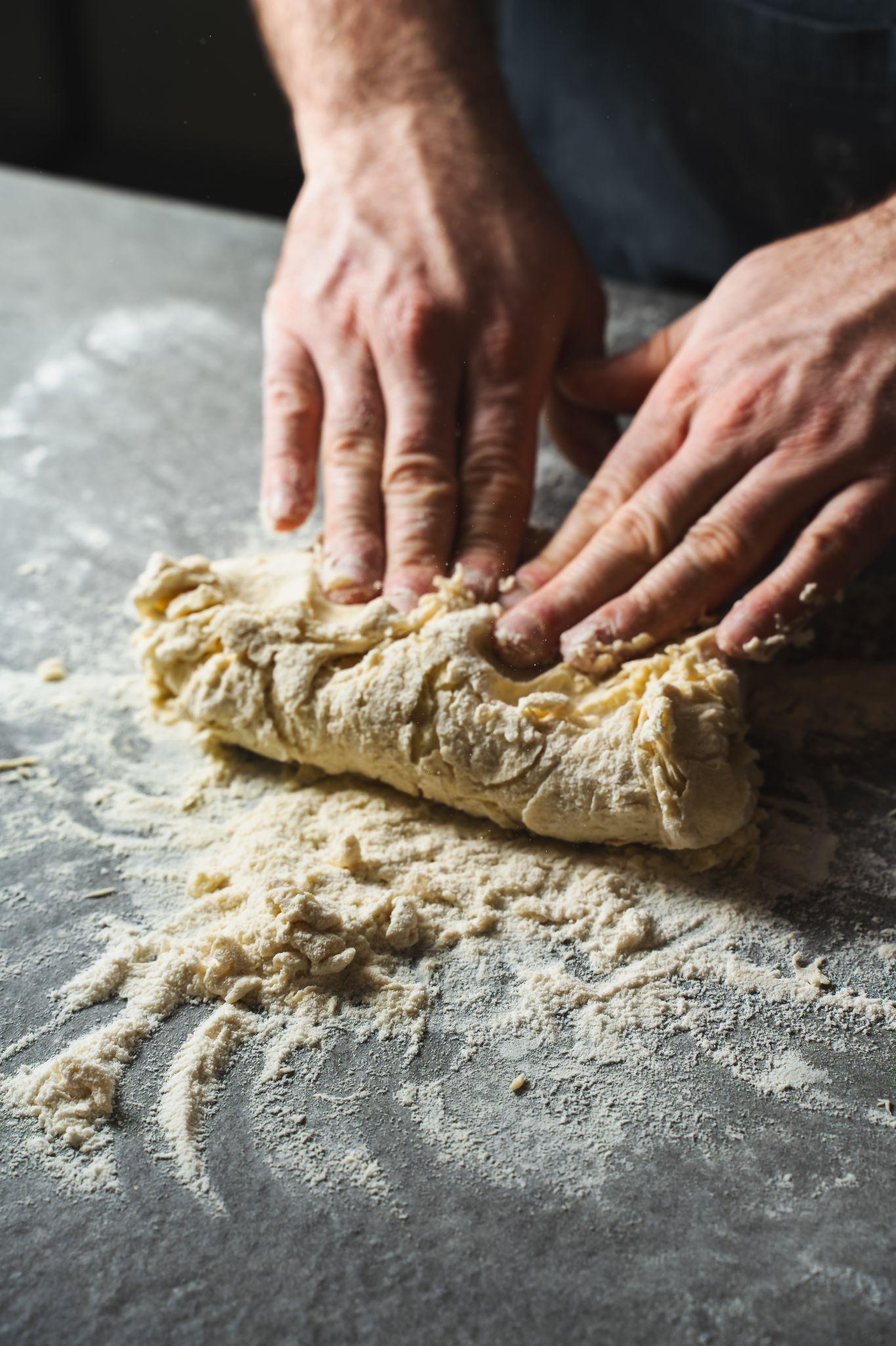Fresh cavatelli pasta shells on a floured surface