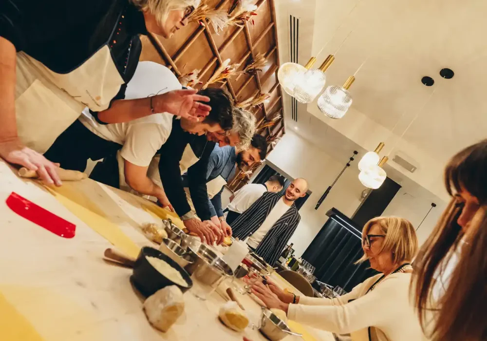 people doing a pasta class with wine tasting